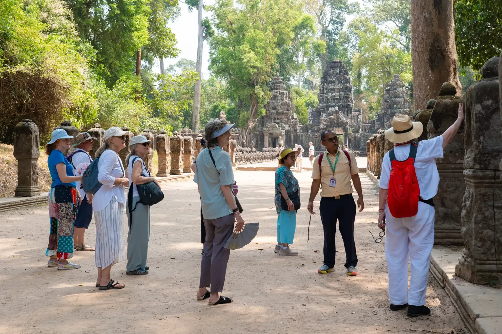 Retreat group walking through ancient temple complex - Cambodia