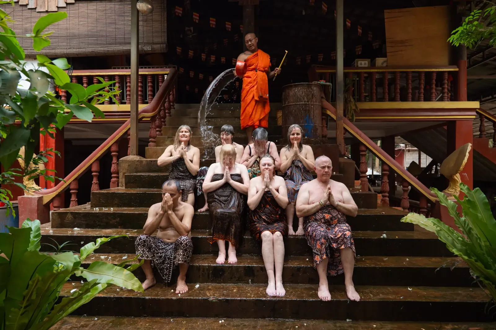 Group gathered inside temple with monks - Cambodia